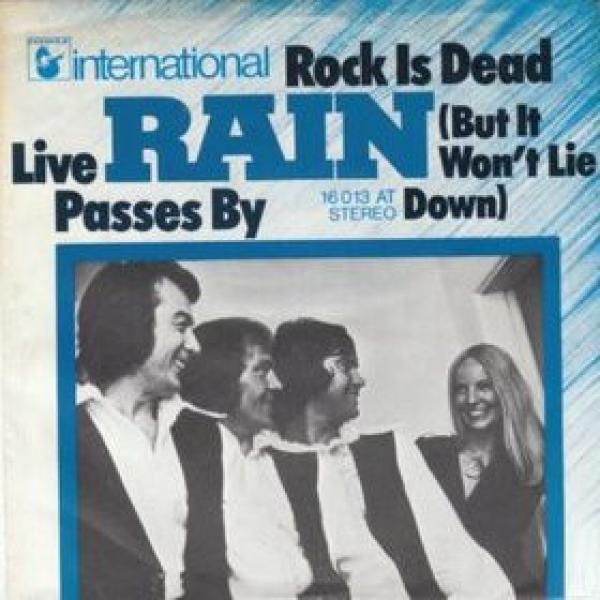 Rain  - Rock Is Dead (But It Won't Lie Down) / Live Passes By